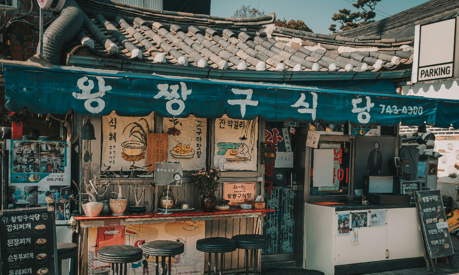 A street food establishment with tall stools lined up along the bar in Seoul, South Korea.