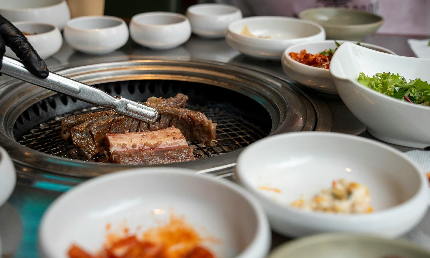 Traditional Korean meat dish prepared and served on the table in bowls.